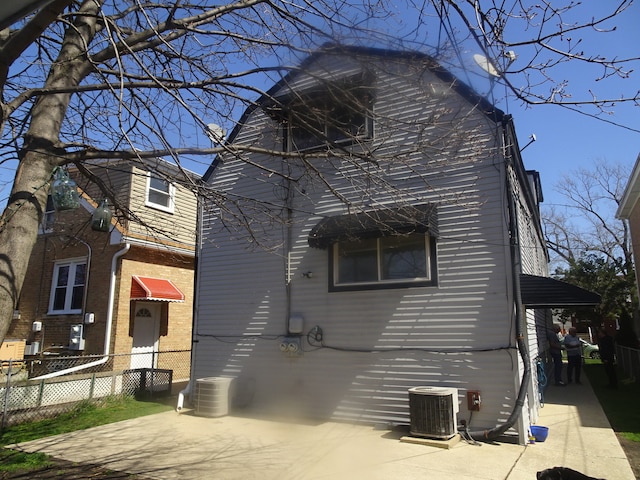 rear view of house with central AC unit