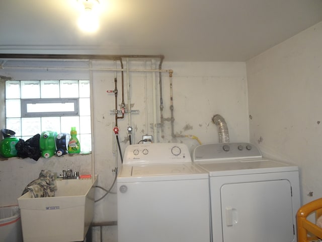 washroom with washer and clothes dryer and sink