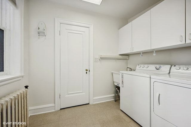 washroom with cabinets, washing machine and dryer, light tile flooring, and radiator heating unit