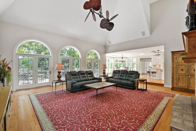 living room featuring plenty of natural light, high vaulted ceiling, and hardwood / wood-style flooring