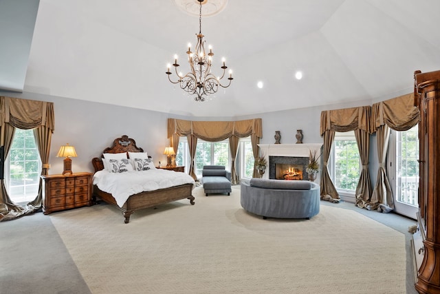 carpeted bedroom featuring lofted ceiling, a notable chandelier, access to outside, and a fireplace