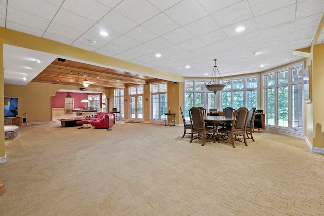 dining space featuring light colored carpet and french doors