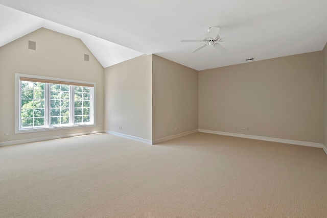 empty room featuring carpet flooring, lofted ceiling, and ceiling fan