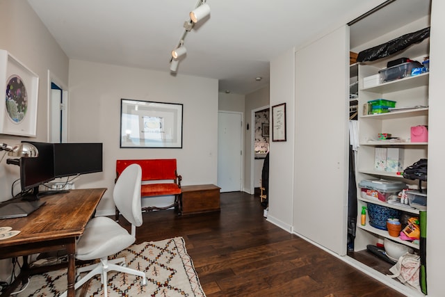 office featuring dark hardwood / wood-style flooring and track lighting