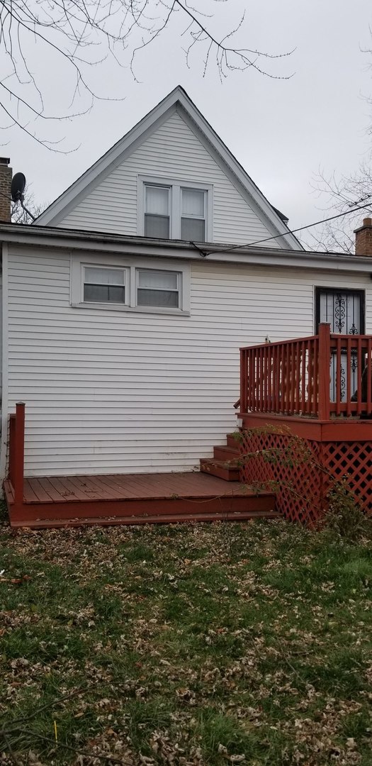 rear view of property with a wooden deck