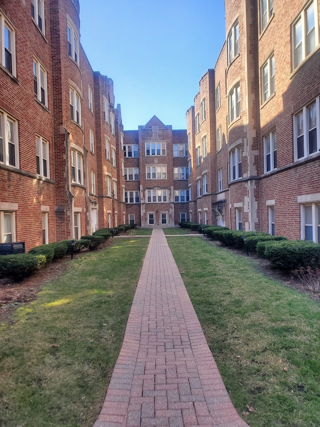 view of home's community featuring a lawn