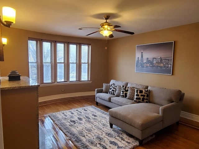 living room featuring dark hardwood / wood-style flooring and ceiling fan