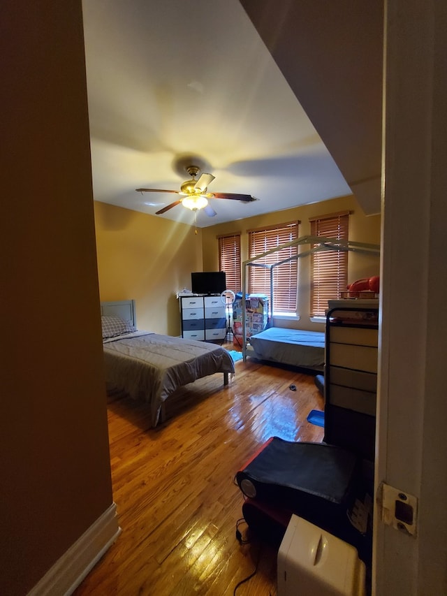 bedroom featuring ceiling fan and hardwood / wood-style flooring