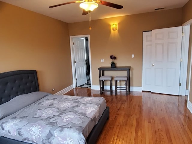 bedroom featuring ceiling fan and dark wood-type flooring