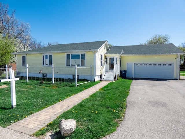 view of front of home featuring a garage and a front yard