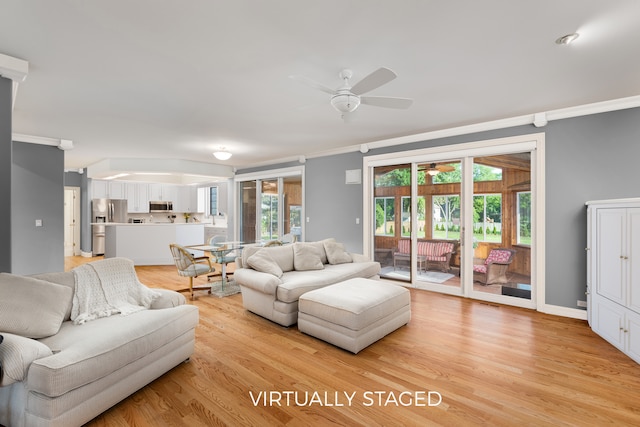 living room with crown molding, ceiling fan, and light wood-type flooring