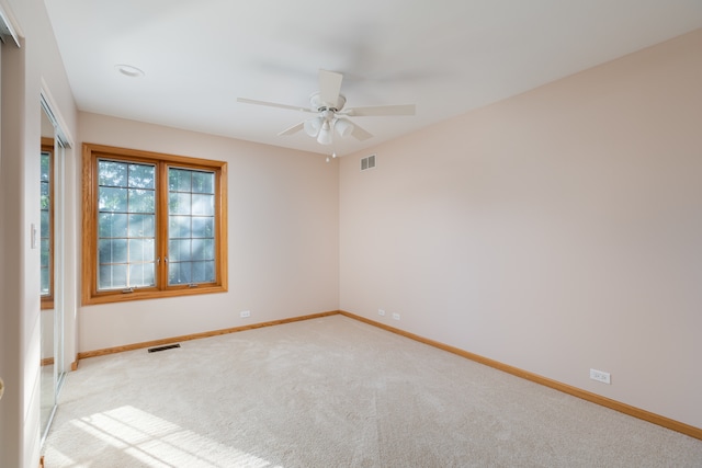 carpeted empty room with ceiling fan