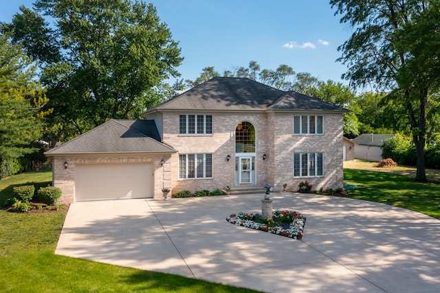 view of front of property featuring a garage and a front yard