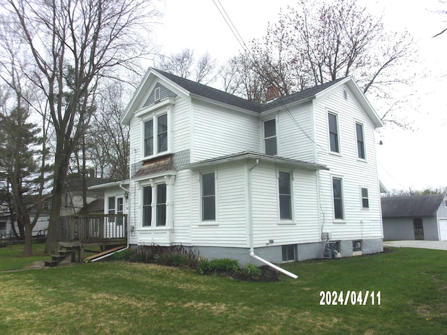 rear view of house with a yard and a garage