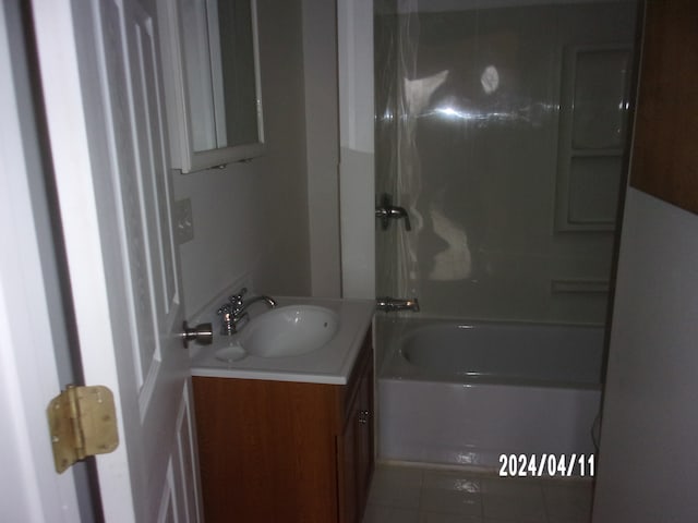 bathroom featuring tile flooring, washtub / shower combination, and large vanity