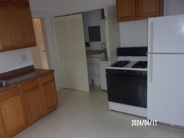 kitchen with white appliances and light tile floors