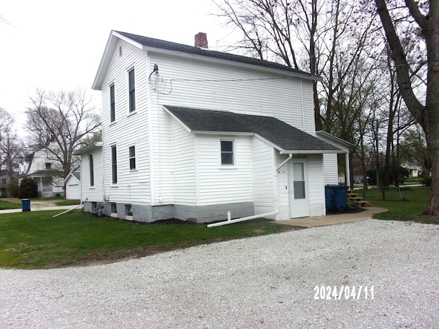 back of property featuring a lawn