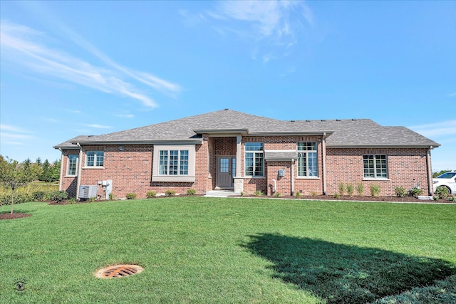 view of front of home with a front lawn and central air condition unit