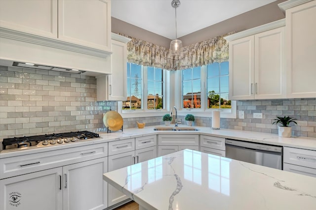 kitchen featuring white cabinets, sink, tasteful backsplash, and stainless steel appliances