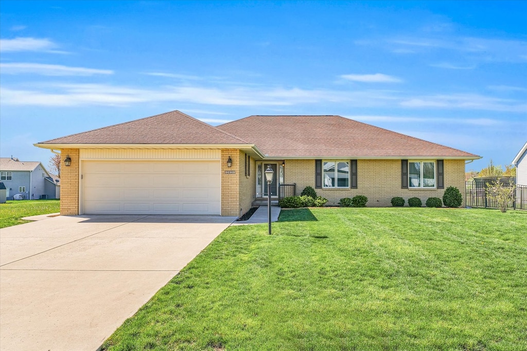 single story home with a front lawn and a garage