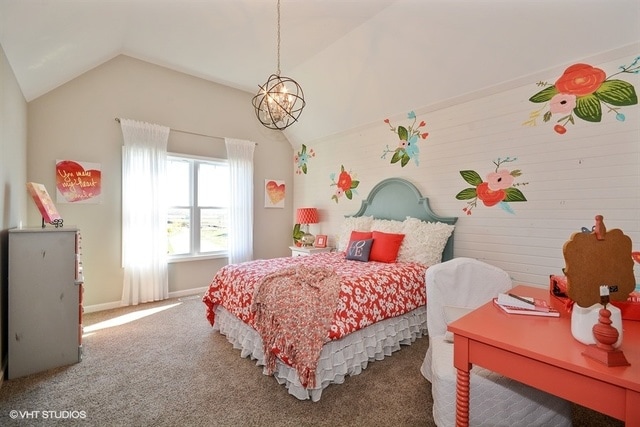 carpeted bedroom featuring vaulted ceiling and a notable chandelier