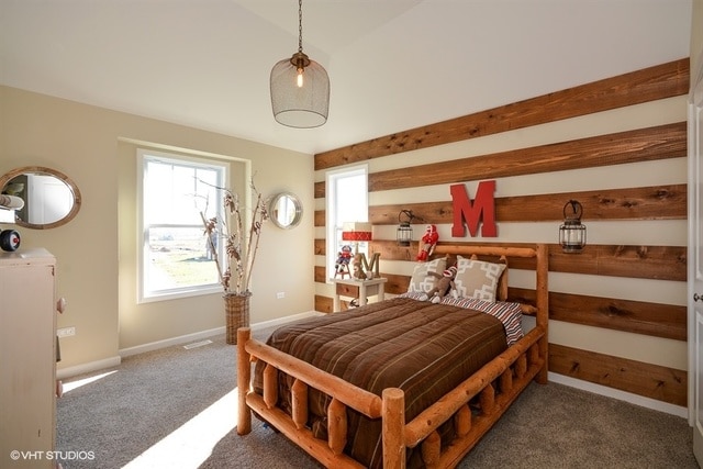 carpeted bedroom featuring lofted ceiling