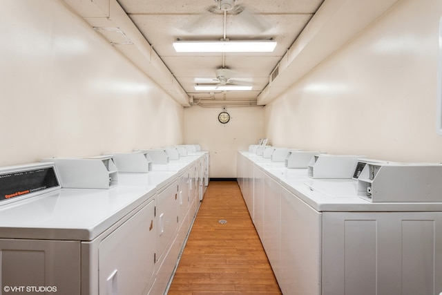 laundry room with light hardwood / wood-style flooring, separate washer and dryer, and ceiling fan