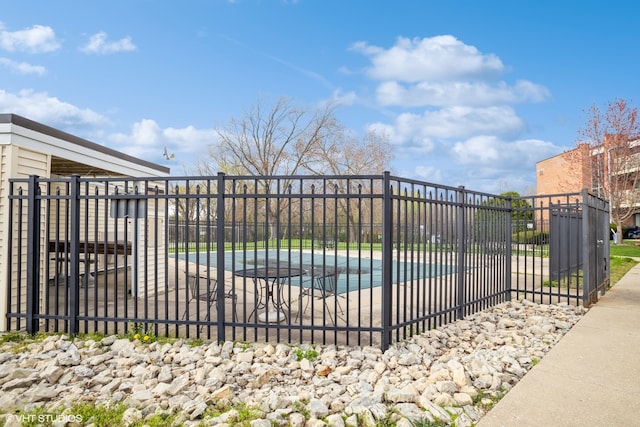 view of gate with a covered pool