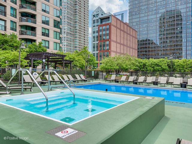 view of swimming pool with a pergola