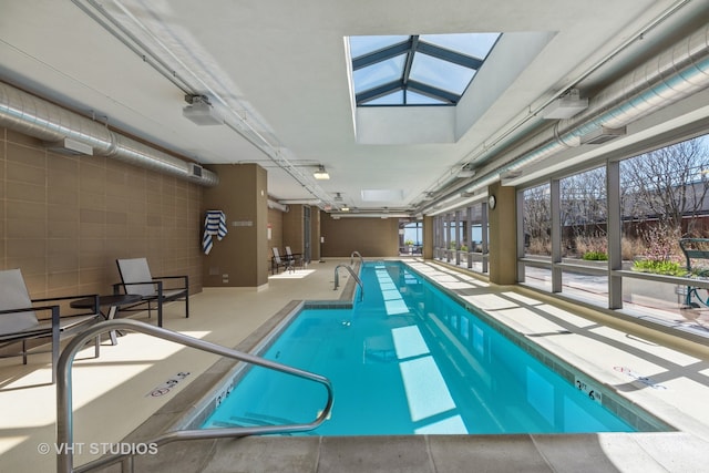 view of swimming pool featuring a skylight