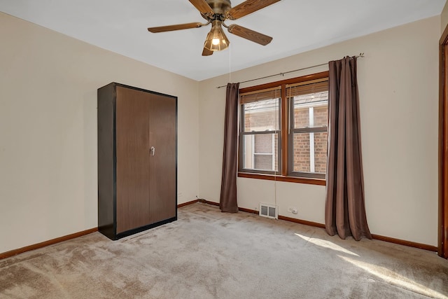 unfurnished bedroom featuring ceiling fan and light carpet