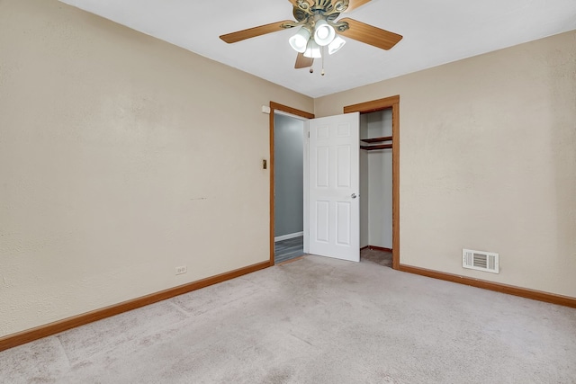 unfurnished bedroom featuring light carpet, a closet, and ceiling fan