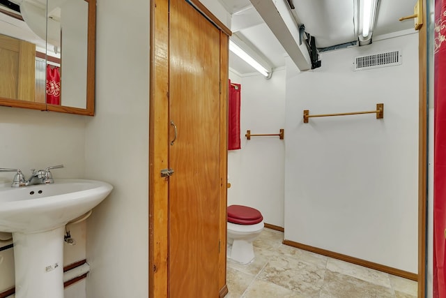 bathroom with toilet and tile flooring