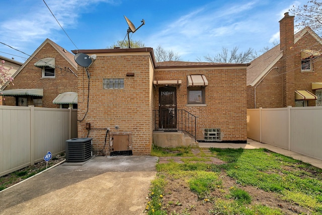 back of property featuring central AC