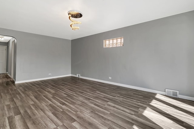 empty room featuring dark hardwood / wood-style flooring