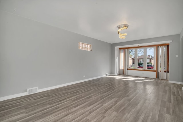 unfurnished room with wood-type flooring