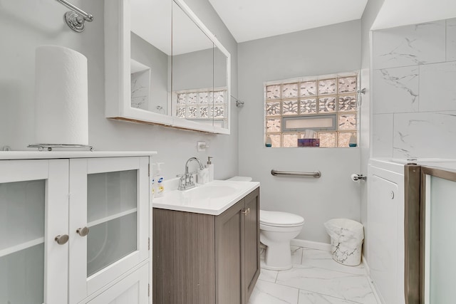 bathroom featuring tile floors, vanity, and toilet