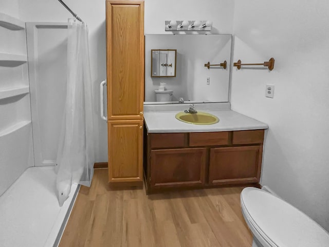 bathroom with oversized vanity, hardwood / wood-style flooring, and toilet