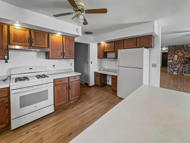 kitchen with white appliances, ceiling fan, and light wood-type flooring