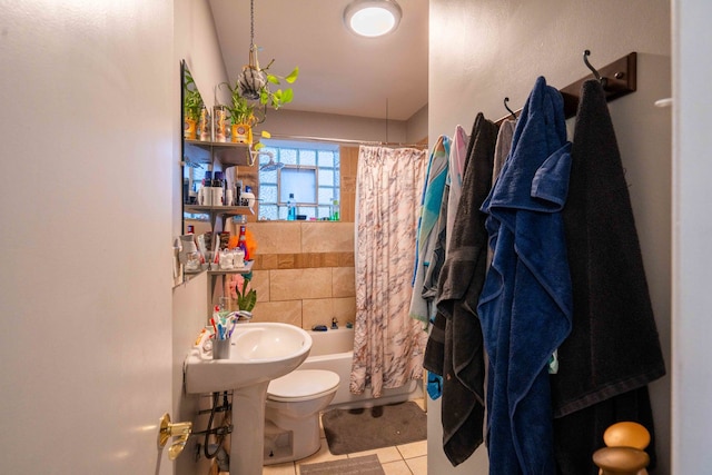 bathroom with shower / tub combo, toilet, and tile flooring