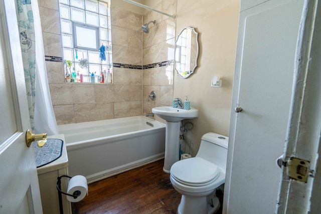 full bathroom featuring sink, wood-type flooring, shower / bath combination with curtain, and toilet