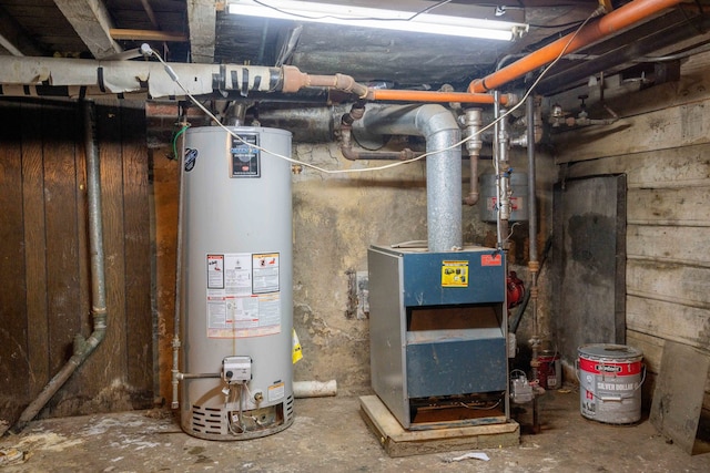 utility room featuring water heater