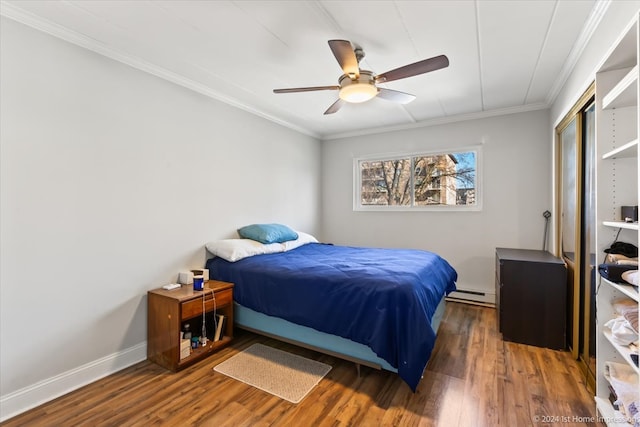 bedroom featuring ornamental molding, ceiling fan, a baseboard heating unit, and dark wood-type flooring