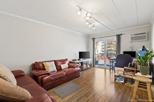 living room with an AC wall unit, crown molding, light hardwood / wood-style floors, and track lighting