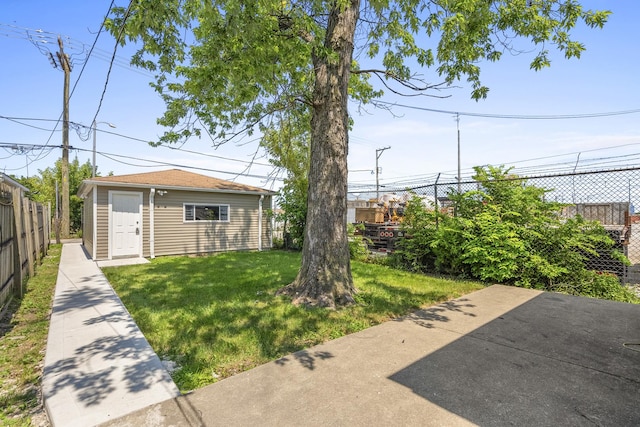 view of yard with a fenced backyard and an outbuilding