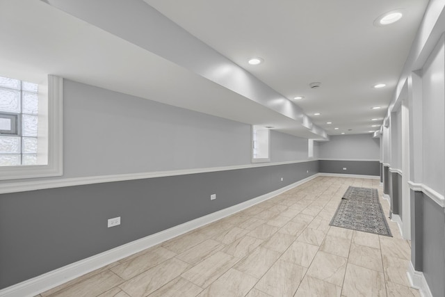 basement with baseboards and recessed lighting