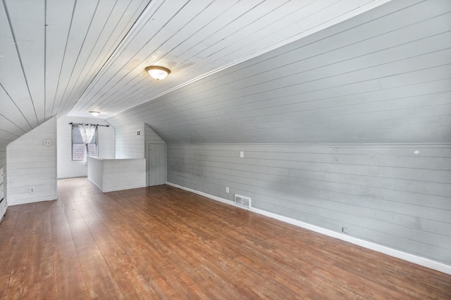 bonus room featuring wooden walls, vaulted ceiling, hardwood / wood-style floors, and wooden ceiling