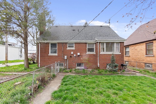 rear view of house featuring a yard