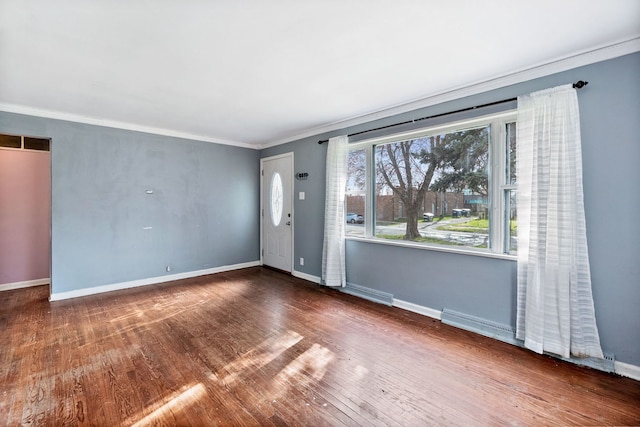 empty room featuring ornamental molding and dark hardwood / wood-style floors