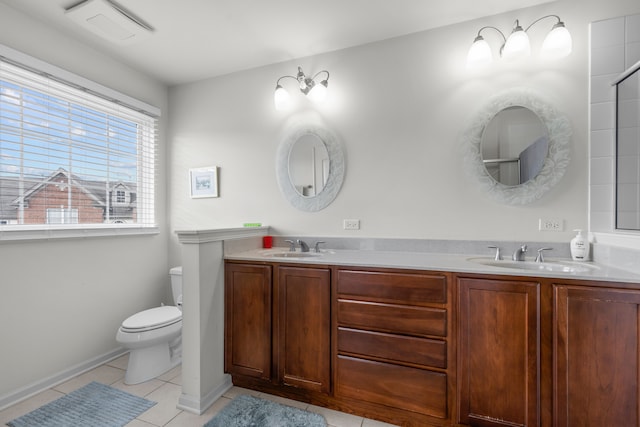 bathroom featuring tile floors, toilet, and dual bowl vanity